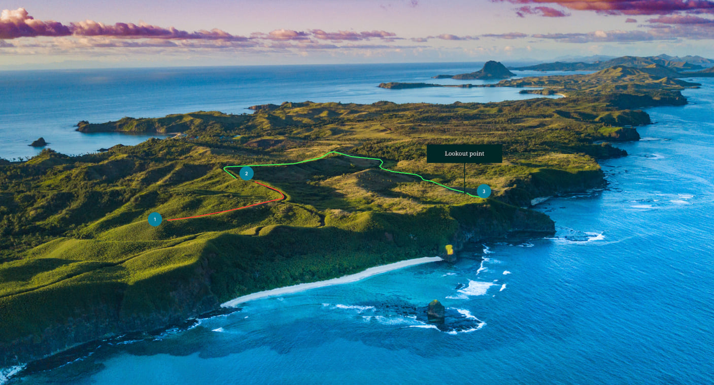 An aerial photograph of a green, hilly island in an ocean, with a route line and some points of interest drawn on the photo.